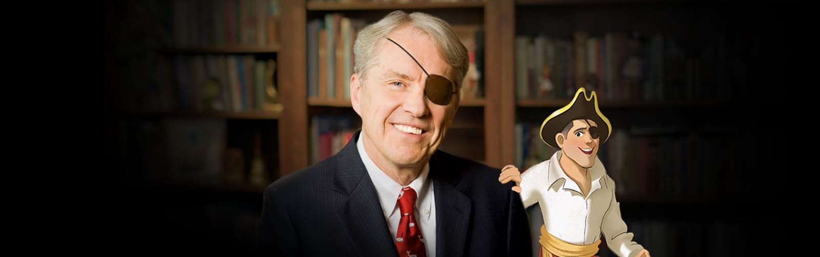 Ron Hamilton, wearing his eye patch, beside the Patch the Pirate character