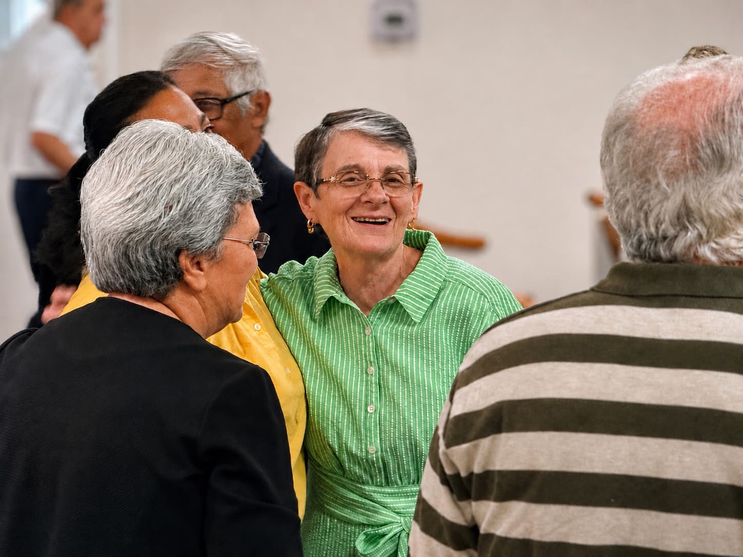 Members talking and smiling together after a service